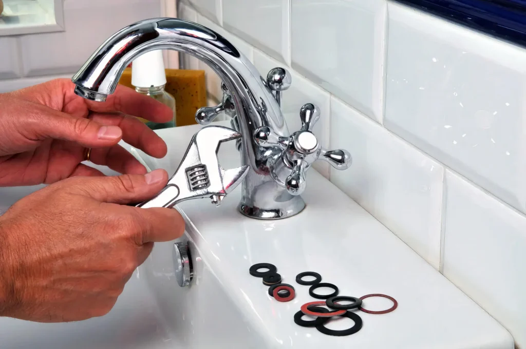 Plumber performing maintenance on a bathroom faucet in Sebastian