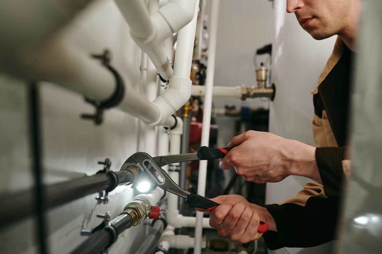 Plumbers maintaining commercial plumbing pipes in Sebastian