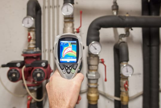 Plumber using a thermal imaging camera to inspect pipes in Sebastian