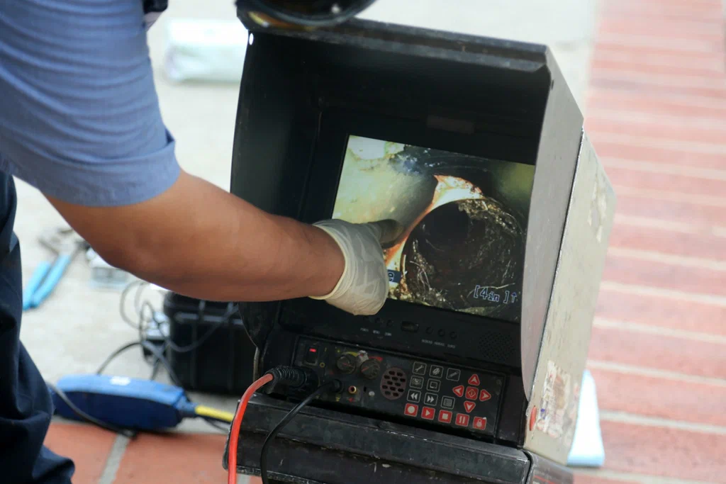 Technician viewing a drain inspection camera in Sebastian
