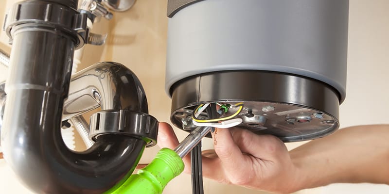 Technician repairing the heating element of a water heater in Sebastian
